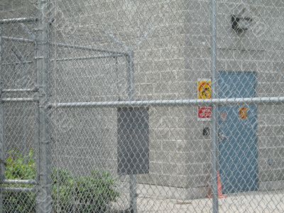 industrial building behind a fence
