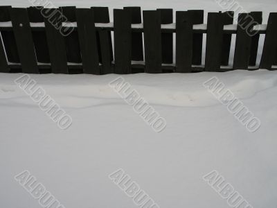 wooden fence with snow