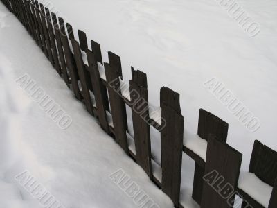 wooden fence with snow