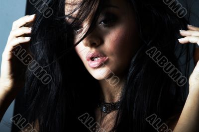 brunette girl posing on dark background