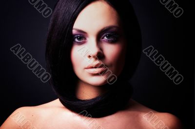 brunette girl posing on dark background