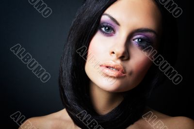 brunette girl posing on dark background