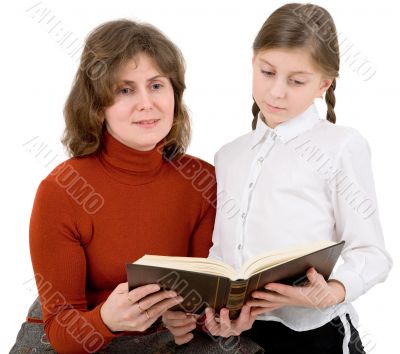 Woman and girl reads the book