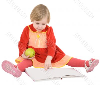 Little girl reads a book