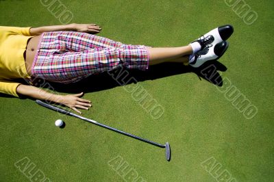 female golfer resting on the green