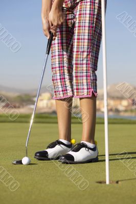  young golfer on putting green