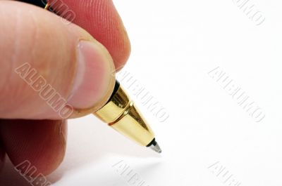 Hand and pen on the white paper