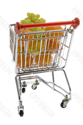 Shopping trolley with fruits, supermarket