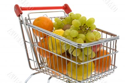 Shopping trolley with fruits, supermarket