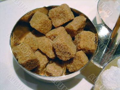 Bowl of brown and cane sugar cubes