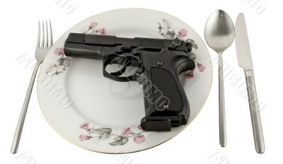 Pistol in a plate on the served table