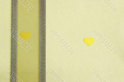 yellow ribbon and golden paper with golden hearts