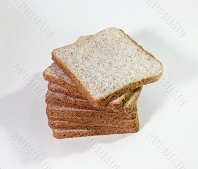 The cut loaf of bread isolated on white