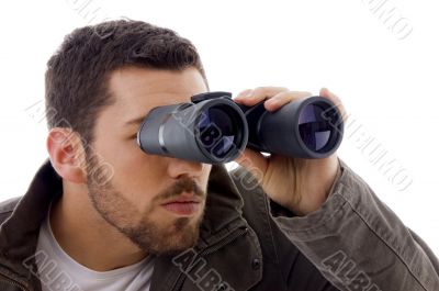 side view of man looking through binoculars
