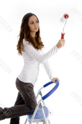 teen girl painting with rolling brush