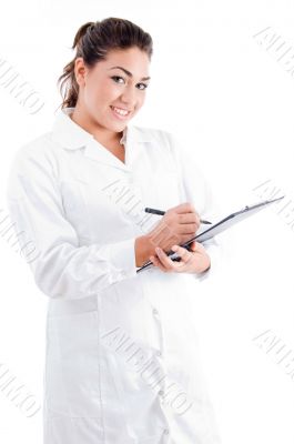 young female doctor writing on notepad
