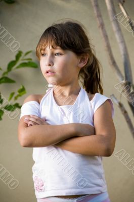 little girl with crossed arms looking side