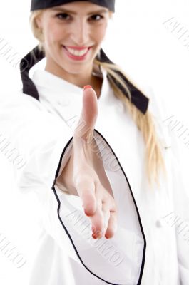 front view of smiling chef offering handshake