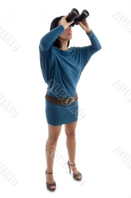 side view of woman looking through binocular
