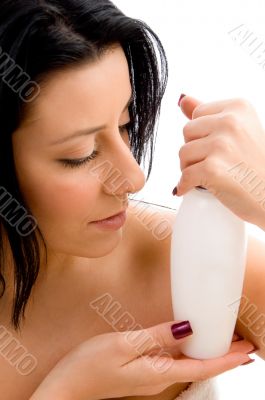 woman posing with lotion bottle