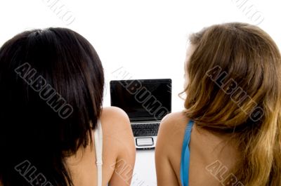 back pose of female students with laptop