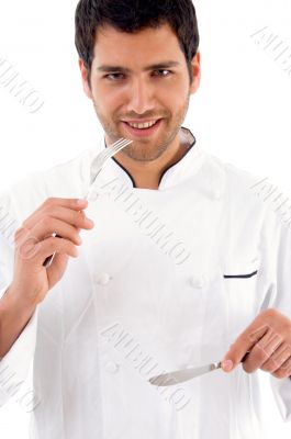 young male chef showing eating etiquettes