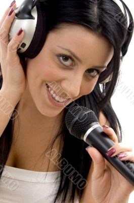 smiling woman posing with headphone and microphone