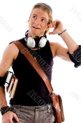 male in thinking pose with bag and books