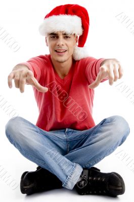 male pointing at camera and wearing christmas hat
