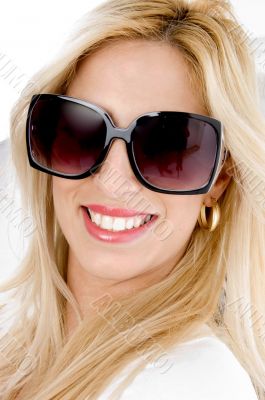 close up of smiling model wearing sunglasses