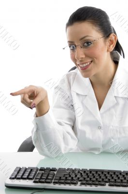 portrait of smiling pointing doctor with keyboard