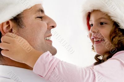 girl pulling father`s ears