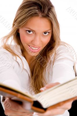 smiling student with book looking at camera