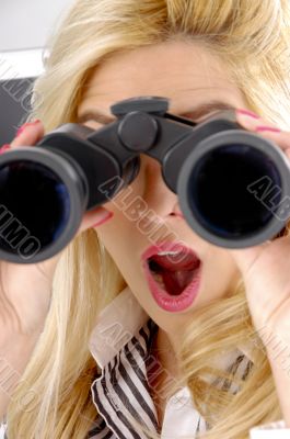 shocked female looking through binocular