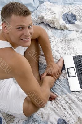 side pose of male with laptop