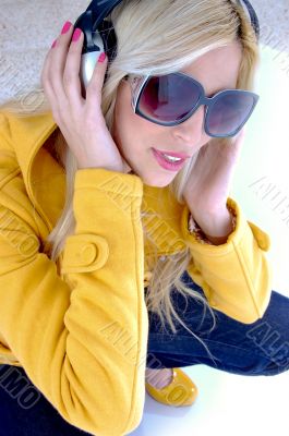top view of model holding headphones
