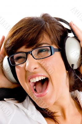 close view of shouting woman listening music