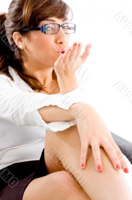 side pose of woman giving flying kiss
