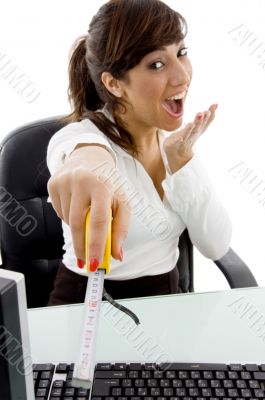 front view of businesswoman holding measuring tape