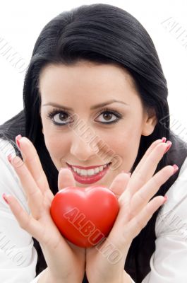 model holding small red heart