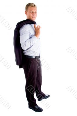 standing man holding his coat