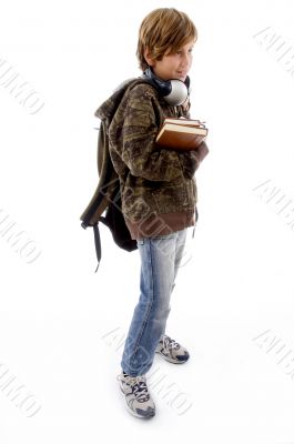 side pose of school boy with books and bag