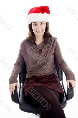 female in christmas hat resting on chair