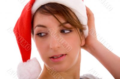 female looking sideways wearing christmas hat