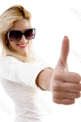 side view of smiling model with thumbs up