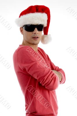 male with folded arms and wearing christmas hat