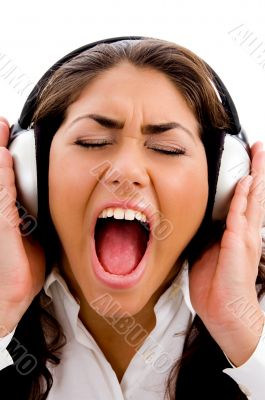 young woman listening to music and singing also