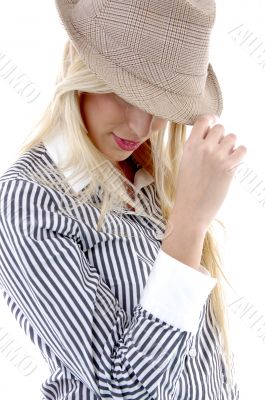 side view of young female holding hat