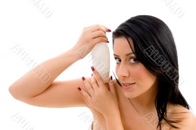 female holding lotion bottle