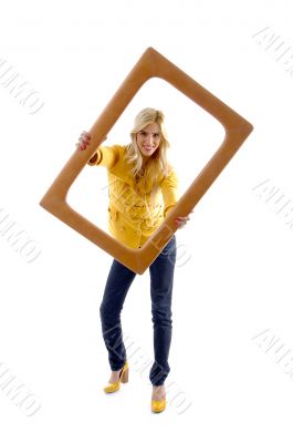 front view of smiling model posing with frame